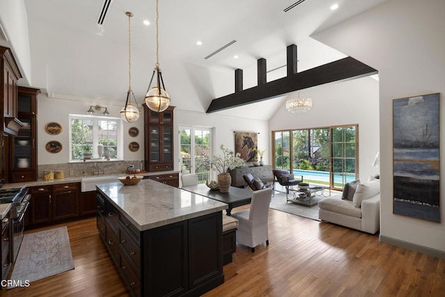 2384 E Orange Grove Blvd, Pasadena, CA 91104 - kitchen featuring open floor plan, a chandelier, glass insert cabinets, a kitchen island, and recessed lighting