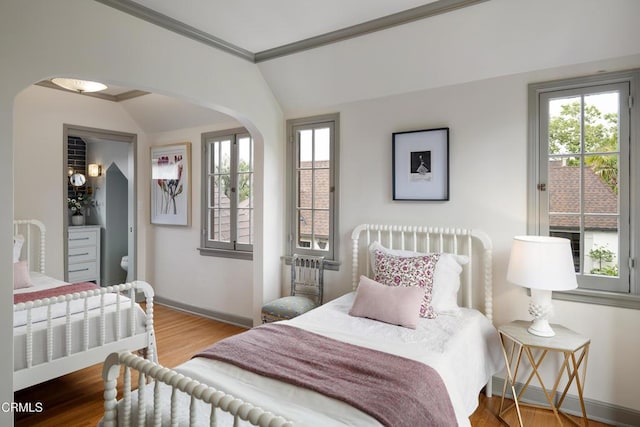 2384 E Orange Grove Blvd, Pasadena, CA 91104 - bedroom with vaulted ceiling, baseboards, multiple windows, arched walkways, and crown molding