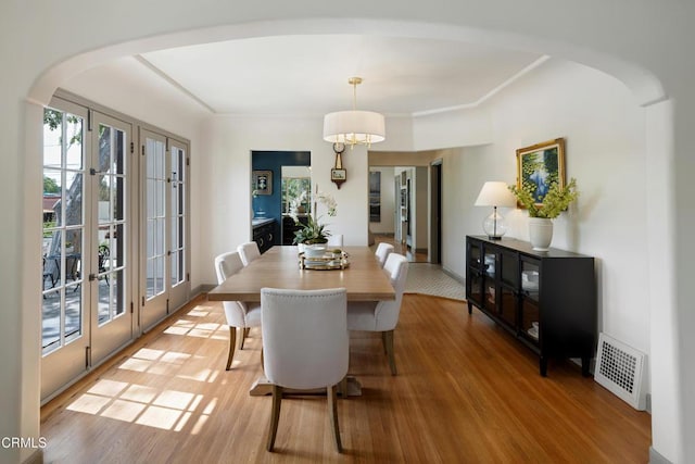 2384 E Orange Grove Blvd, Pasadena, CA 91104 - dining room featuring french doors, arched walkways, and light wood-style floors