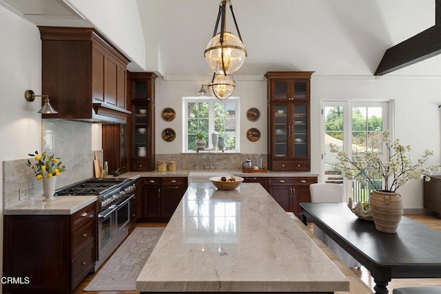 2384 E Orange Grove Blvd, Pasadena, CA 91104 - kitchen featuring double oven range, plenty of natural light, decorative backsplash, and ornamental molding