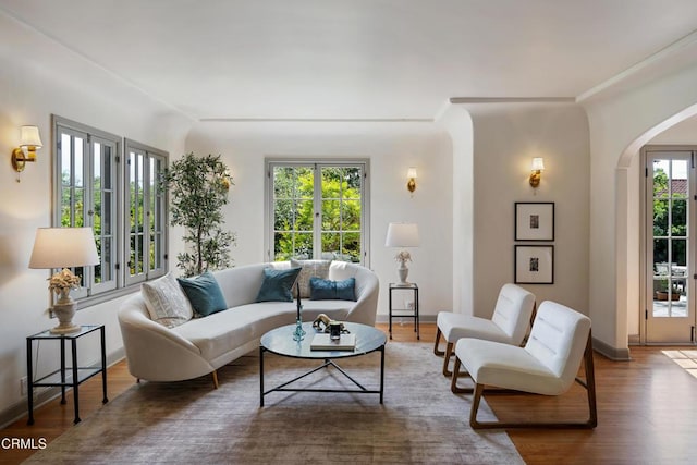 2384 E Orange Grove Blvd, Pasadena, CA 91104 - living room featuring arched walkways, wood finished floors, and baseboards