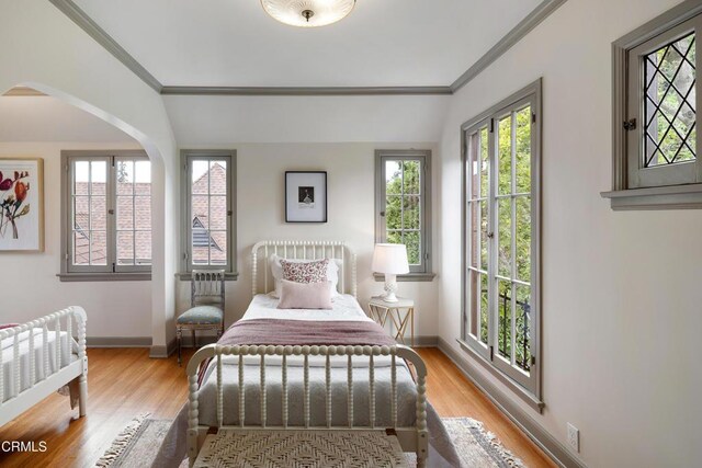 2384 E Orange Grove Blvd, Pasadena, CA 91104 - bedroom featuring ornamental molding, light wood finished floors, baseboards, and arched walkways