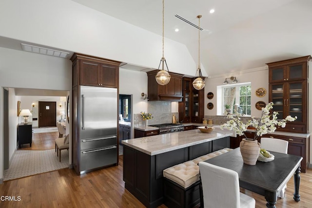 2384 E Orange Grove Blvd, Pasadena, CA 91104 - kitchen featuring built in fridge, range, tasteful backsplash, glass insert cabinets, and wood finished floors