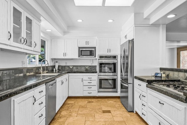 1923 Hidden Mesa Rd, El Cajon, CA 92019 - kitchen with stainless steel appliances, white cabinets, a sink, dark countertops, and glass insert cabinets