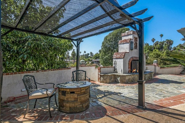 1923 Hidden Mesa Rd, El Cajon, CA 92019 - view of patio with a lit fireplace and a fire pit