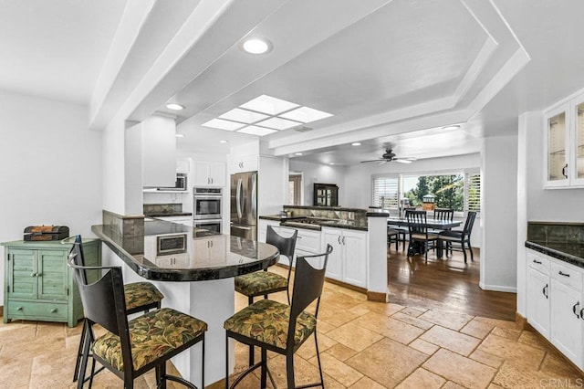 1923 Hidden Mesa Rd, El Cajon, CA 92019 - kitchen featuring a peninsula, appliances with stainless steel finishes, a kitchen bar, white cabinets, and recessed lighting