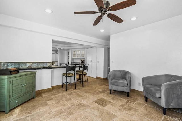 1923 Hidden Mesa Rd, El Cajon, CA 92019 - kitchen with light stone finish flooring, ceiling fan, dark countertops, a breakfast bar, and recessed lighting