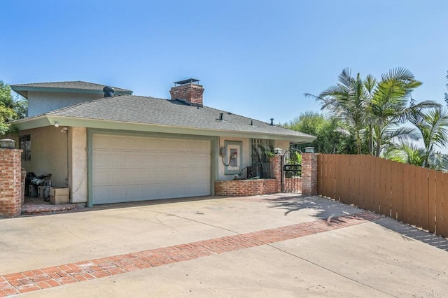1923 Hidden Mesa Rd, El Cajon, CA 92019 - view of front facade with concrete driveway, stucco siding, a gate, a garage, and a chimney