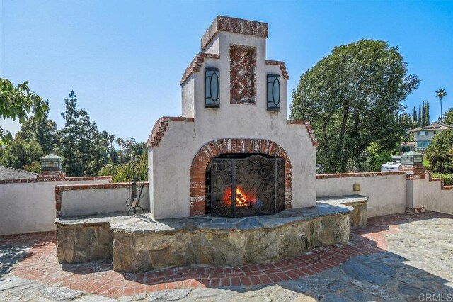 1923 Hidden Mesa Rd, El Cajon, CA 92019 - view of patio / terrace with an outdoor brick fireplace