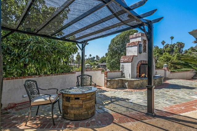 1923 Hidden Mesa Rd, El Cajon, CA 92019 - view of patio with a warm lit fireplace and a fire pit