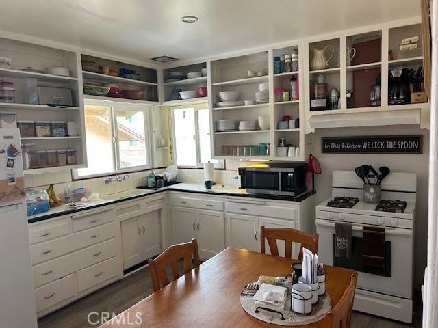 12758 5th St, Yucaipa, CA 92399 - kitchen with white appliances, open shelves, backsplash, and white cabinetry