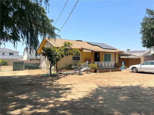 12758 5th St, Yucaipa, CA 92399 - view of front of property featuring solar panels, covered porch, and a shingled roof