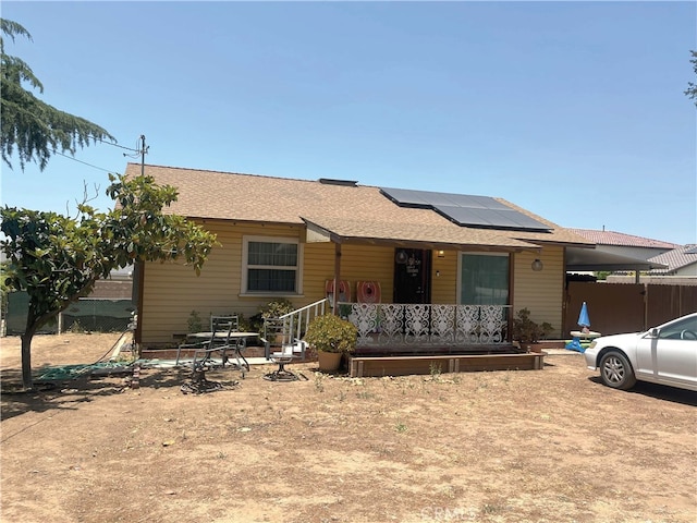 12758 5th St, Yucaipa, CA 92399 - view of front of property with roof mounted solar panels and roof with shingles