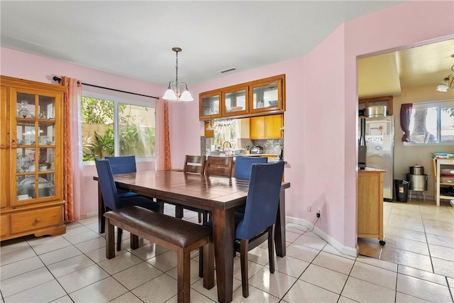 11889 Gale Ave, Hawthorne, CA 90250 - dining area featuring a chandelier, light tile patterned floors, and baseboards