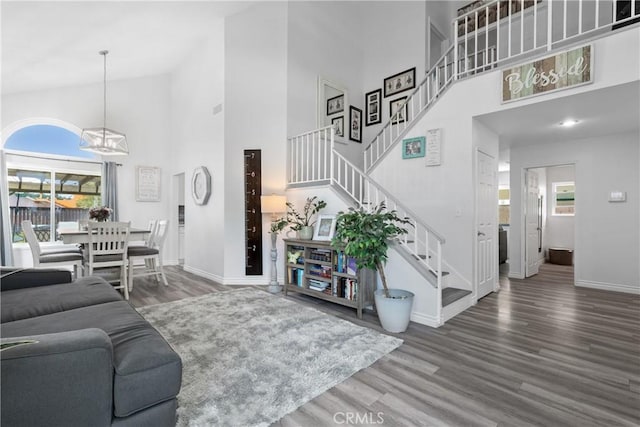 39985 Falcon Way, Murrieta, CA 92562 - living room featuring high vaulted ceiling, a chandelier, baseboards, wood finished floors, and stairs