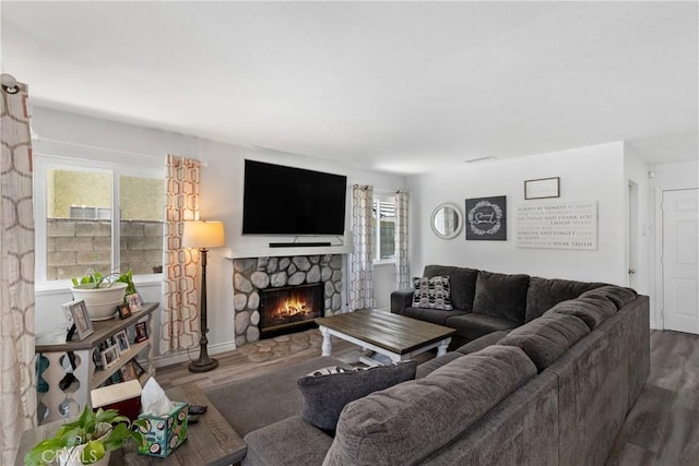39985 Falcon Way, Murrieta, CA 92562 - living room featuring wood finished floors, a stone fireplace, and healthy amount of natural light