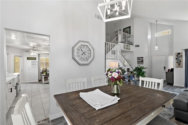 39985 Falcon Way, Murrieta, CA 92562 - dining room with stairs, a towering ceiling, baseboards, ceiling fan, and a chandelier