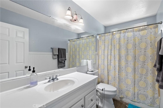 39985 Falcon Way, Murrieta, CA 92562 - bathroom featuring toilet, vanity, wood finished floors, and wainscoting