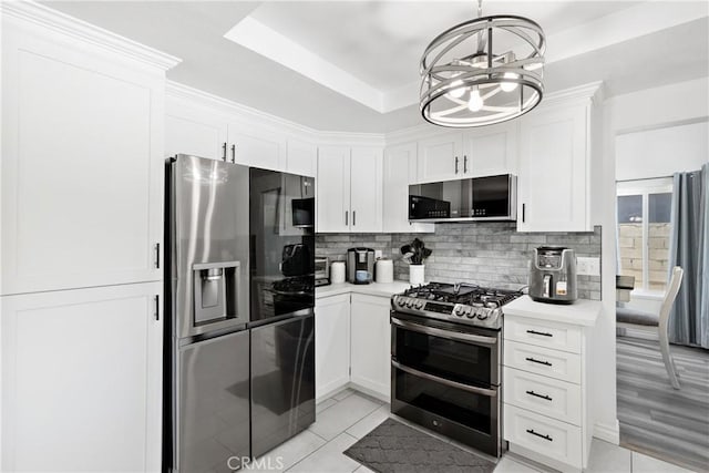 39985 Falcon Way, Murrieta, CA 92562 - kitchen with appliances with stainless steel finishes, tasteful backsplash, light countertops, white cabinetry, and a chandelier