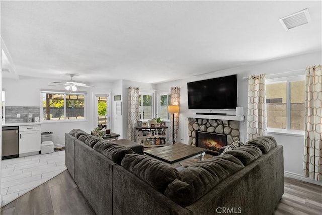 39985 Falcon Way, Murrieta, CA 92562 - living area featuring a fireplace, light wood finished floors, and a ceiling fan