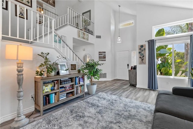 39985 Falcon Way, Murrieta, CA 92562 - living area featuring wood finished floors, baseboards, stairs, and high vaulted ceiling