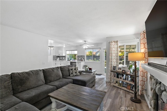 39985 Falcon Way, Murrieta, CA 92562 - living room featuring wood finished floors, a fireplace, and ceiling fan