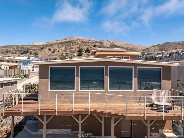 3352 Studio Dr, Cayucos, CA 93430 - back of property with a deck with mountain view and stucco siding