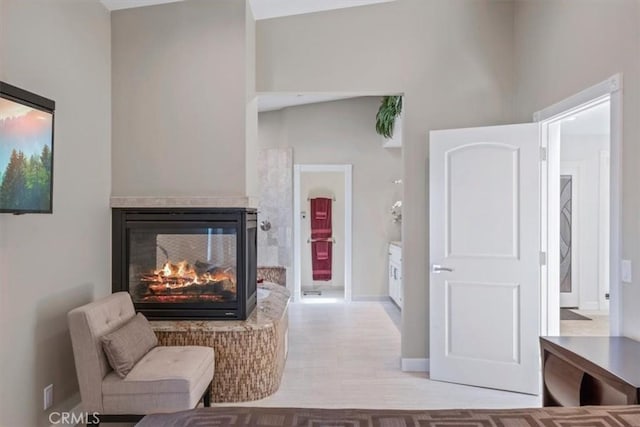 3352 Studio Dr, Cayucos, CA 93430 - living area featuring a multi sided fireplace, baseboards, and wood finished floors