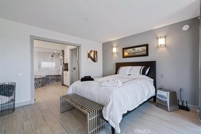 3352 Studio Dr, Cayucos, CA 93430 - bedroom featuring light wood-style floors, baseboards, and ensuite bathroom