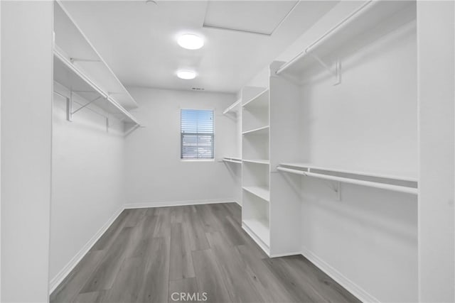 13153 Stanton Dr, Rancho Cucamonga, CA 91739 - walk in closet featuring wood finished floors and attic access