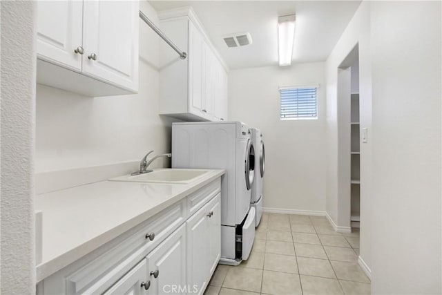 13153 Stanton Dr, Rancho Cucamonga, CA 91739 - laundry room featuring cabinet space, independent washer and dryer, light tile patterned flooring, and baseboards