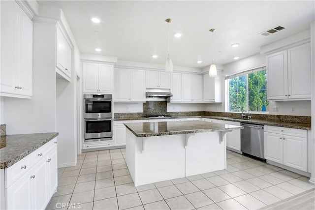13153 Stanton Dr, Rancho Cucamonga, CA 91739 - kitchen featuring stainless steel appliances, a sink, white cabinetry, a kitchen island, and under cabinet range hood