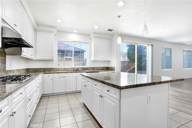 13153 Stanton Dr, Rancho Cucamonga, CA 91739 - kitchen featuring stainless steel gas stovetop, a kitchen island, under cabinet range hood, and light tile patterned floors