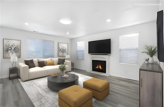 13153 Stanton Dr, Rancho Cucamonga, CA 91739 - living room with light wood finished floors, plenty of natural light, a lit fireplace, baseboards, and recessed lighting