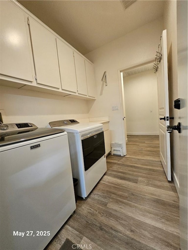 200 Janzen Way, Hemet, CA 92545 - laundry area featuring separate washer and dryer, cabinet space, wood finished floors, and baseboards