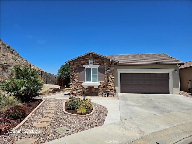 200 Janzen Way, Hemet, CA 92545 - view of front of property featuring concrete driveway, a tiled roof, a garage, stone siding, and stucco siding