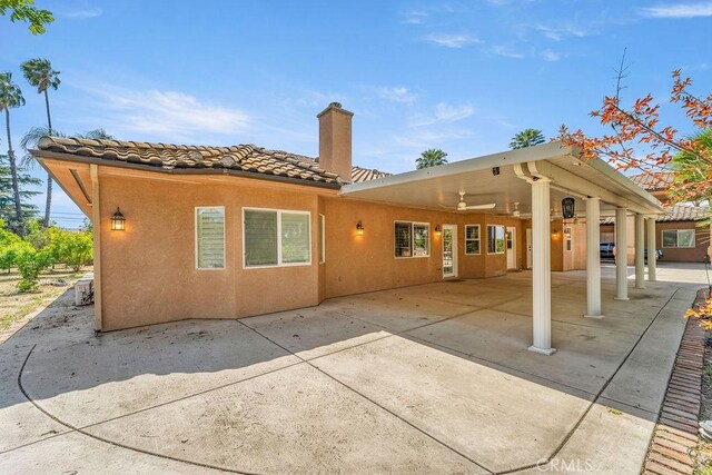 2189 Myers St, Riverside, CA 92503 - back of property featuring a chimney, a tile roof, a patio, a ceiling fan, and stucco siding