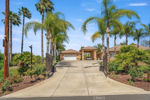 2189 Myers St, Riverside, CA 92503 - mediterranean / spanish home with a detached garage, stucco siding, driveway, and a gate