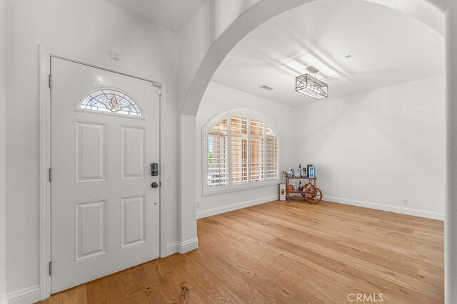 2189 Myers St, Riverside, CA 92503 - foyer with arched walkways, wood finished floors, and baseboards
