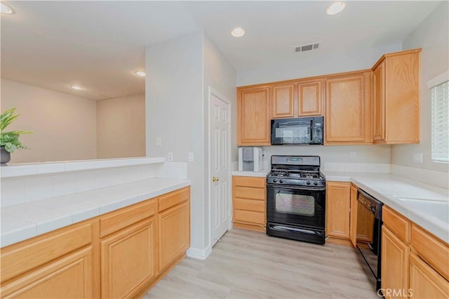 9135 W Rancho Park Cir, Rancho Cucamonga, CA 91730 - kitchen with black appliances, light wood finished floors, light brown cabinetry, and recessed lighting