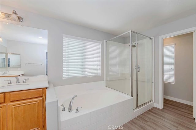 9135 W Rancho Park Cir, Rancho Cucamonga, CA 91730 - full bath featuring a shower stall, vanity, a garden tub, and wood finished floors