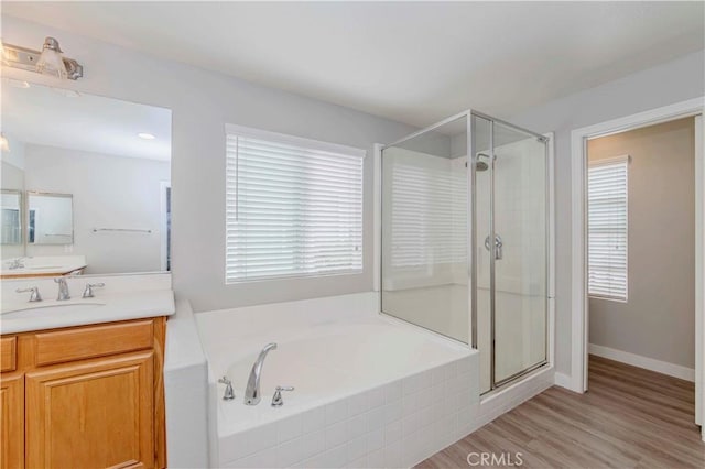 9135 W Rancho Park Cir, Rancho Cucamonga, CA 91730 - bathroom featuring a stall shower, vanity, a garden tub, and wood finished floors