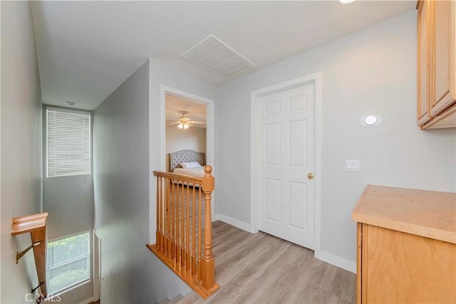 9135 W Rancho Park Cir, Rancho Cucamonga, CA 91730 - hallway featuring an upstairs landing, light wood-type flooring, and baseboards