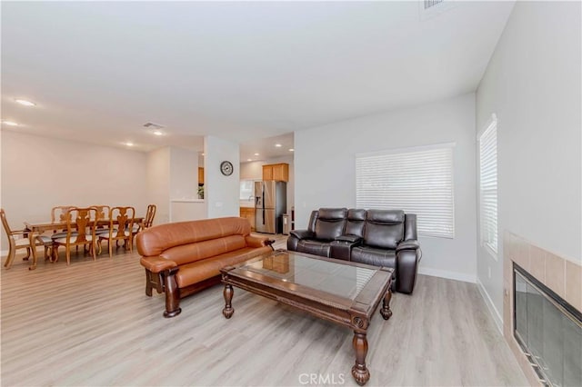 9135 W Rancho Park Cir, Rancho Cucamonga, CA 91730 - living area featuring light wood-style flooring, a tiled fireplace, baseboards, and recessed lighting