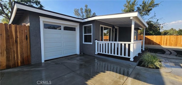 5818 Tyler St, Riverside, CA 92503 - view of front of home with a porch, stucco siding, a garage, and driveway