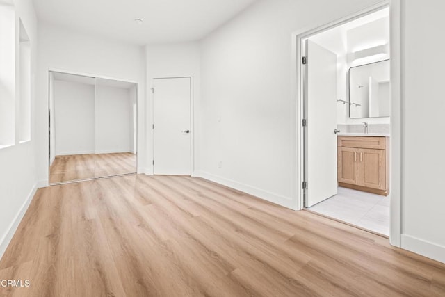 5333 Monte Vista St, Highland Park, CA 90042 - unfurnished bedroom featuring light wood-type flooring, a closet, baseboards, and a sink