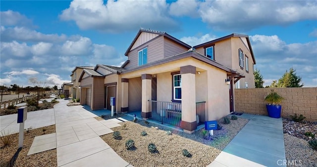 7651 Taylor Ave, Hesperia, CA 92345 - view of front of home featuring covered porch, an attached garage, and stucco siding