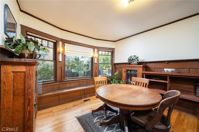 125 W 11th St, Claremont, CA 91711 - dining space featuring crown molding, wood finished floors, and a wainscoted wall