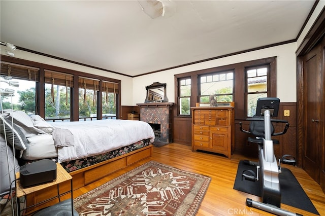 125 W 11th St, Claremont, CA 91711 - bedroom with light wood-type flooring, wainscoting, ornamental molding, and a fireplace