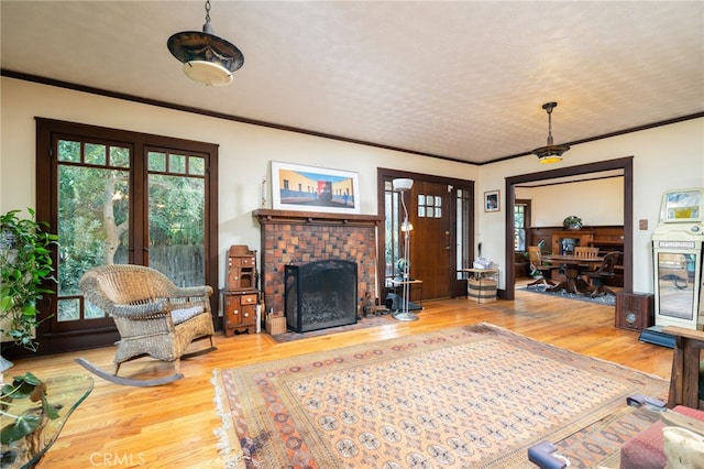 125 W 11th St, Claremont, CA 91711 - living room featuring wood finished floors, ornamental molding, and a brick fireplace